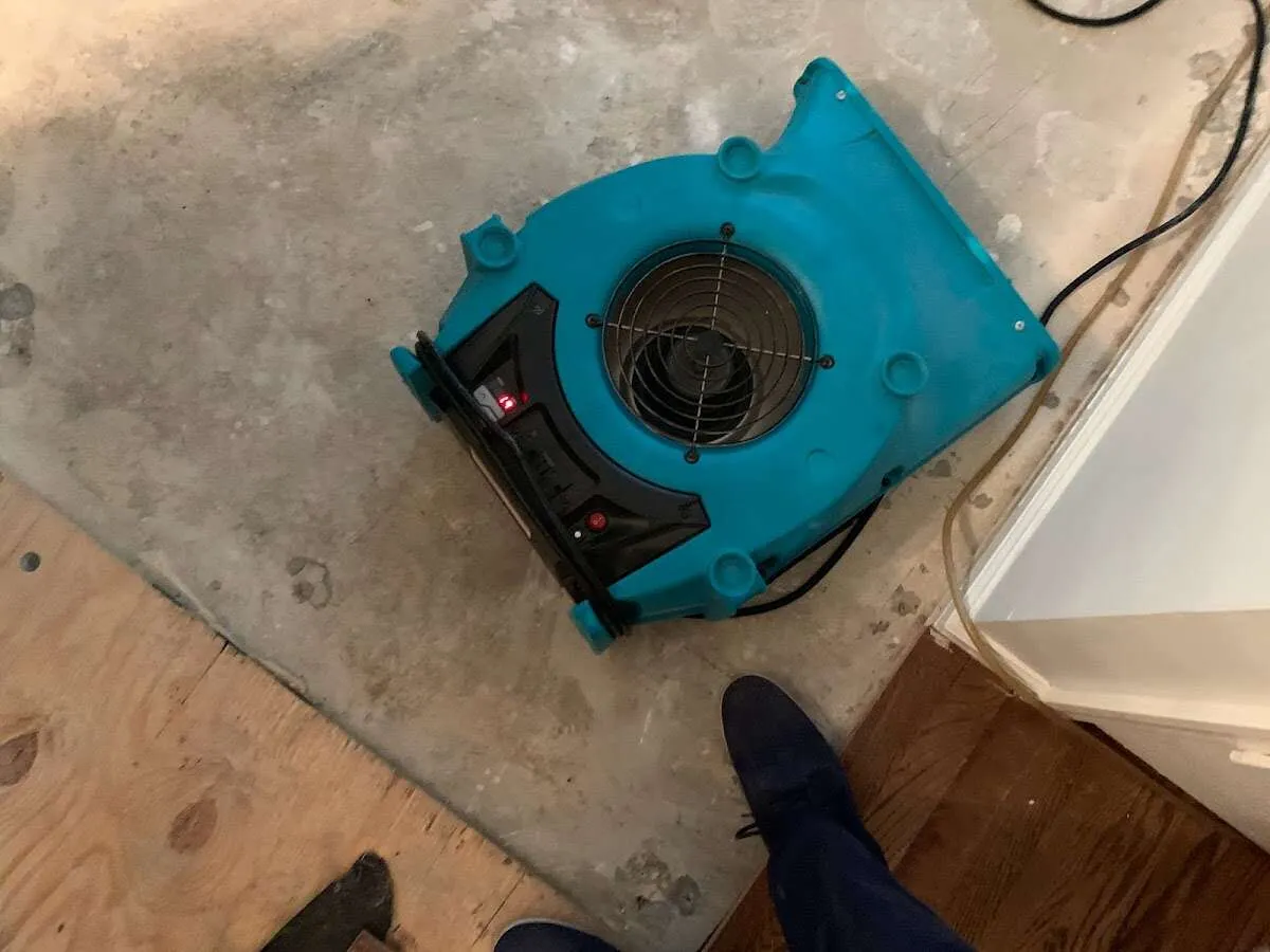 Air mover drying subfloor during Commercial Water Damage Restoration in Kirksville